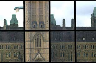 View of Parliament Hill through windows of historical 100 Wellington Street building