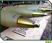 105 mm artillery rounds sit ready for a fire mission. The brass coloured tips are the fuses that determine how the projectile will explode when it arrives on target.