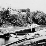 Photograph of Centre Block under construction, with Rideau Canal in foreground, ca.1862