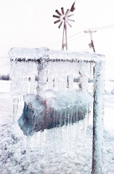 Photograph of a rural mailbox, completely encased in ice, near Farnham, Quebec, January 1998