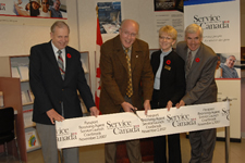 Jim Abbott, Member of Parliament for Kootenay-Columbia (second from left), cuts the ribbon to officially launch Passport Receiving Agent services at the Service Canada Centre in Cranbrook, British Columbia, on November 2, 2007. Also pictured (left to right) are James E. Ogilvie, Mayor of Kimberley, Jo Ann Hall, Director, Southern Interior Service Area, Service Canada, and Ross Priest, Mayor of Cranbrook.