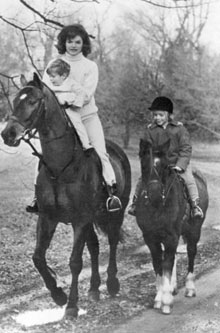 Jacqueline Kennedy with her children Caroline, right, and John Jr. on horseback in November 1962. 