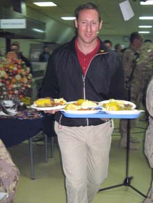 Defence Minister Peter MacKay serves up Christmas dinner to Canadian troops at the airfield in Kandahar, Afghanistan, on Tuesday.