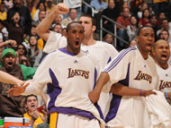 Kobe Bryant, centre, takes time to cheer on his teammates from the bench during the Lakers' 122-115 Christmas Day win over visiting Phoenix. Bryant led all scorers with 38 points.