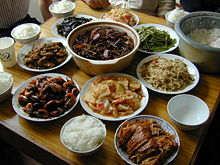 Chinese meal in Suzhou with rice, shrimp, eggplant, fermented tofu, vegetable stir-fry, vegetarian duck with meat and bamboo