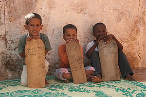 Young madrasah pupils in Mauritania. They learn parts of the Qur'an from wooden tablets.