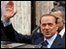 Italian Prime Minister Silvio Berlusconi waves as he leaves a memorial mass for his mother in Rome, 26 February  