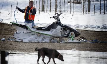 A damaged snowmobile retrieved from the scene of the avalanche by helicopter on Sunday.