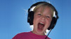 Kid wearing headphones. Photo by flattop341