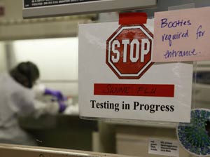 Beth Weiman, a lead microbiologist, tests a suspected swine flu sample at the Washington State Public Health Laboratories Thursday, April 30, 2009, in Shoreline, Wash.