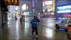 Woman hurries through rain in Times Square (28/08/11)