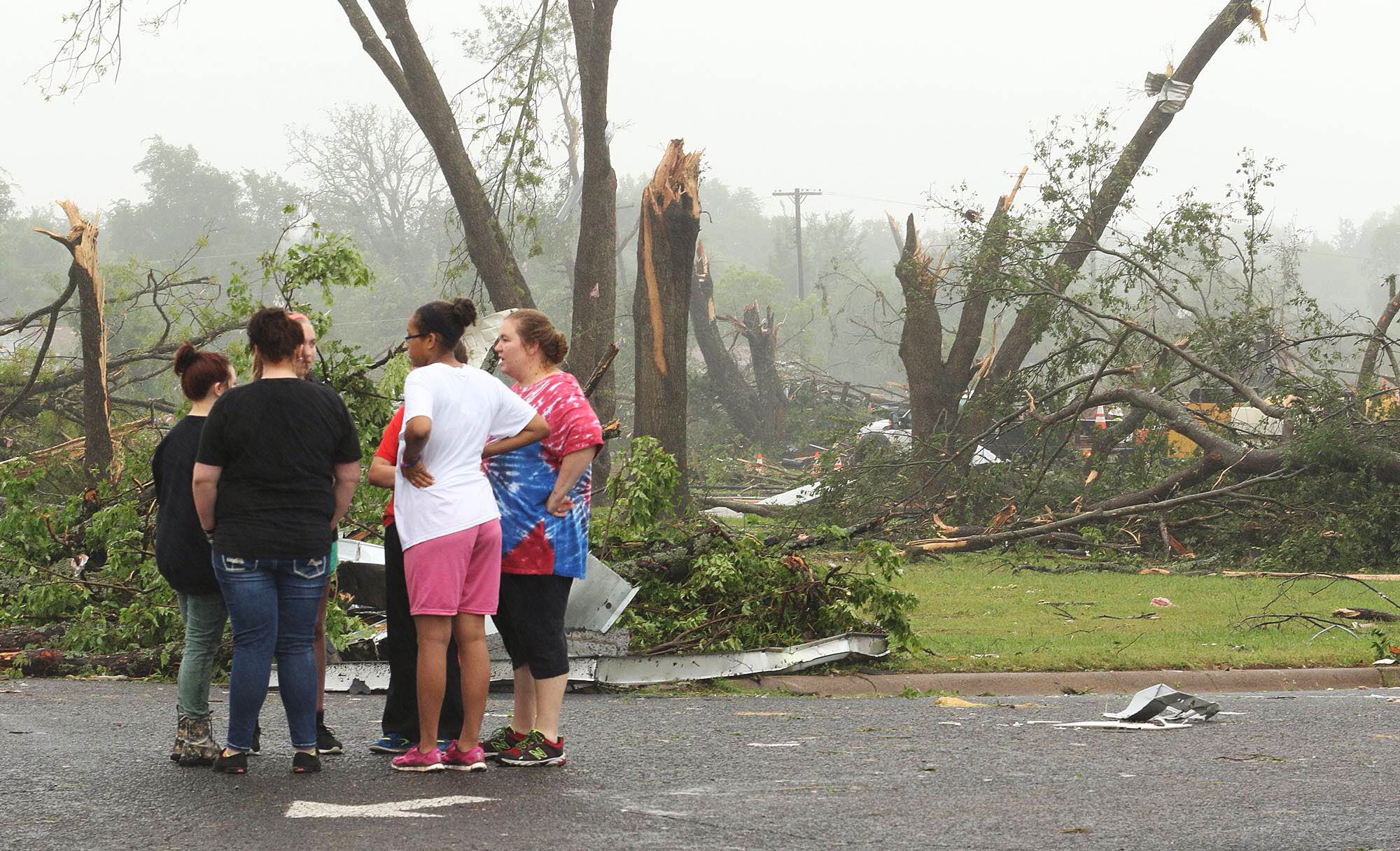 Residents survey damage near an elementary school, caused by severe weather in Van, Texas. About 30 per cent of the community was damaged from the storm late Sunday, according to Chuck Allen, fire marshal and emergency management coordinator for Van Zandt County. 