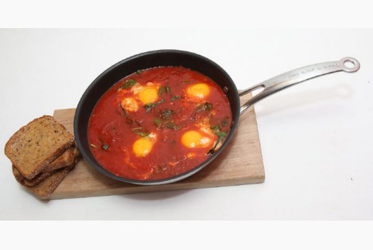 Who doesn't love breakfast for dinner? All you need is a jar of tomato sauce, some eggs and a handful of spinach to make this dish.