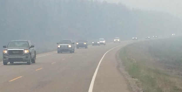 Sask Wildfires LaRonge 20150704 cars evacuation