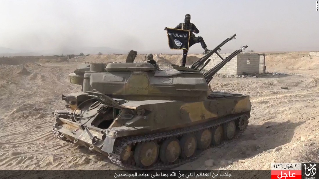 In this image taken from social media, an ISIS fighter holds the group&#39;s flag as he stands on a purportedly captured tank after the militant group &lt;a href=&quot;http://www.cnn.com/2015/08/07/world/syria-isis-al-qaryatayn-christians/index.html&quot; target=&quot;_blank&quot;&gt;overran the Syrian town of al-Qaryatayn&lt;/a&gt; on Thursday, August 6, the London-based Syrian Observatory for Human Rights reported.