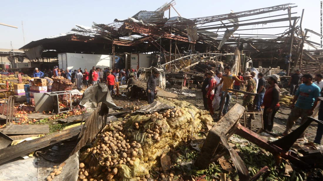 Iraqi men look at the damage following a bomb explosion that targeted a vegetable market in Baghdad&#39;s northern Shiite district of Sadr City on Thursday, August 13. ISIS claimed responsibility for the attack. 