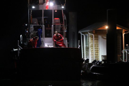 A Canadian Coast Guard crew arrives at a dock in Tofino, B.C., shortly after midnight on Monday following a search-and-rescue operation. First responders managed to rescue 21 passengers, some of them injured. The search for one person who was still missing was called off Sunday night and the RCMP was handling it as a missing-person case.

