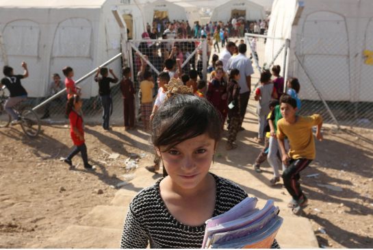 A Yazidi refugee girl from the minority Yazidi sect poses for a photograph on the first day of school at Sharya refugee camp, on the outskirts of Duhok province, earlier this month.