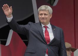 Le Premier ministre Stephen Harper salue la foule après avoir prononcé un discours lors de la célébration de la Fête du Canada sur la colline du Parlement.
