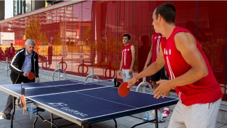 Prime Minister Stephen Harper plays table tennis with Matthew Buie, a member of Canada's rowing team, at Canada House in the Pan Am Athletes' Village prior to attending the opening ceremony of the 2015 Pan American Games. 