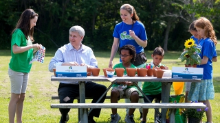 Prime Minister Stephen Harper joins Earth Rangers in planting flowers at the Pickering Recreation Complex prior to announcing a significant expansion of Rouge National Urban Park, making it one of the largest urban parks in North America.