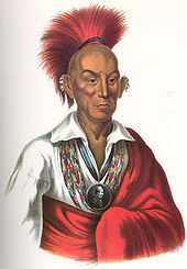Native American chief with red headdress and red robe