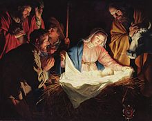 A Nativity scene; men and animals surround Mary and newborn Jesus, who are covered in light