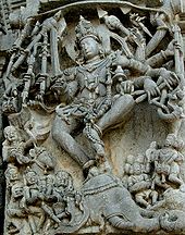 Relief sculpture of deity with 10 arms and people below