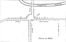 A black-and-white map, depicting buildings and roads in simple, small black outlines. The text "Utica in 1802" is at bottom right.