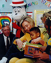 Clinton reads a book to an African American grade school class