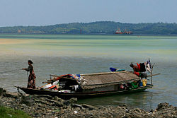 Sama-Bajau woman anchoring a family boat (banglo) in Malaysia