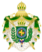Coat of arms consisting of a shield with a green field with a golden armillary sphere superimposed on the red and white Cross of the Order of Christ, surrounded by a blue band with 20 silver stars; the bearers are two arms of a wreath, with a coffee branch on the left and a flowering tobacco branch on the right; and above the shield is an arched golden and jeweled crown