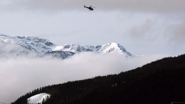 A search and rescue helicopter heads toward the area where a large avalanche struck near Revelstoke, B.C., in this Sunday, March 14, 2010 file photo. Five snowmobilers have died in a "very large'' avalanche near the interior community of McBride, B.C., on Friday, prompting a rescue and recovery operation. 