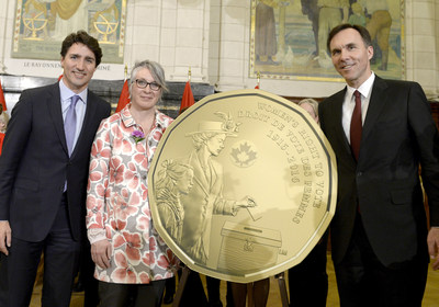 The Right Honourable Justin Trudeau, Prime Minister of Canada, the Honourable Patty Hajdu, Minister of Status of Women and the Honourable Bill Morneau, Minister of Finance unveil a new one-dollar circulation coin to commemorate the 100th anniversary of women’s right to vote in Canada. (CNW Group/Royal Canadian Mint)
