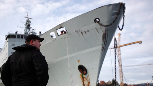 Royal Canadian Navy personnel watches over the HMCS Protecteur, a supply ship that was decommissioned last year. The Liberal budget tabled last week once again pushes funding for defence projects, such as new ships for the navy, down the road to when - hopefully - new ships are ready to require payment.