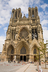 Notre-Dame de Reims facade, gothic stone cathedral against blue sky