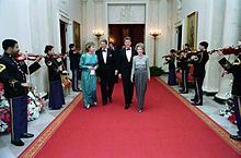 The Reagans and the Clintons walking a red carpet
