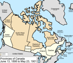 alt=Map of the country of Canada on June 13, 1898, depicting the larger postage stamp sized province of Manitoba along with the provinces of Ontario, Prince Edward Island, Quebec, New Brunswick, British Columbia and Nova Scotia, in the colour white. The disputed area between Manitoba and Ontario is resolved, Ontario expands west to the Lake of the Woods and north to the Albany River. The North-West Territories is separate from the District of Keewatin. Territories are depicted in the colour pink; the northern arctic islands are a part of the NWT. The District of Keewatin now has a geographically shaped border to encompass the eastern borders of the newly formed provisional districts of the NWT. Yukon Territory is now formed from the NWT. The area called Newfoundland, Labrador, and Alaska are depicted in bluish grey colour, and are not a part of Canada.