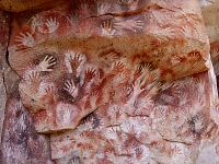 Stencilled hands on the cave's wall