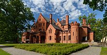 red stone manor house in neo-gothic style