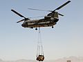 An Australian Army Chinook helicopter lifting a front loader in Afghanistan during 2012