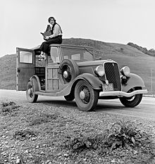 Dorothea Lange atop automobile in California.jpg