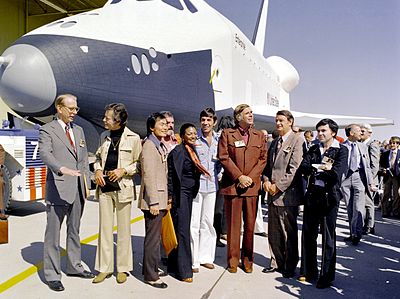 The crew of Star Trek alongside the Space Shuttle Enterprise.