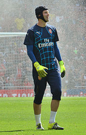 A colour photograph of Petr Čech, warming up in Arsenal training gear.