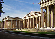 A museum building designed in the Greek Revival style with a flag on top.