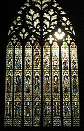 A very large window of eight lights rising to elaborate tracery in the form of a sacred heart