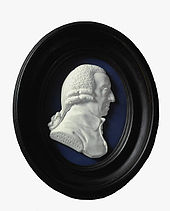 An enamel paste medallion, depicting a man's head facing the right
