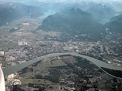 Maple Ridge looking north; Fraser River and Derby (Old Fort Langley) in foreground, Pitt Meadows at left