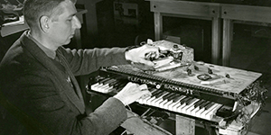 Photo of a man sitting beside the first synthesizer