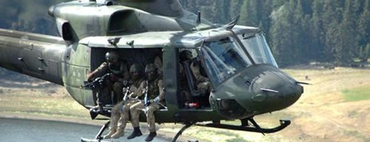 Military personnel sitting in a helicopter